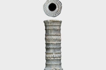 The ancient red pigment was held in an intricately decorated chlorite vial.