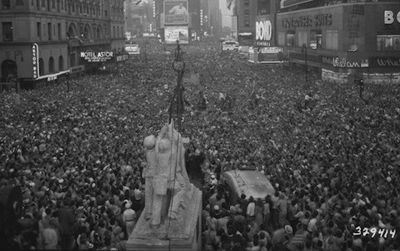 A crowd gathers in Times Square in 1945. Since then, we’ve added a few more people to the population.