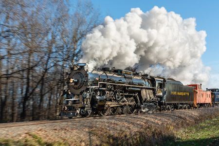 A steam locomotive with smoke billowing
