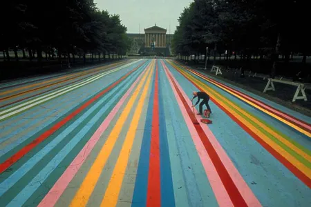 Gene Davis at work on his painting Franklin's Footpath, created on the street outside of the Philadelphia Museum of Art in 1972.