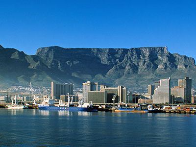 Table Mountain is a flat-topped granite and sandstone massif that rises 3,562 feet above Cape Town, South Africa.