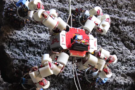 The latest iteration of the four-legged LEMUR exploration robot clings to a test rock surface in Aaron Parness’ lab in a recent test of its microspine capabilities.