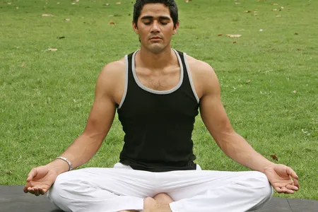 A yoga instructor practices a breathing exercise.