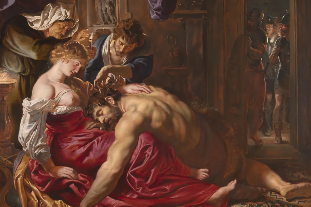 A large painting depicting a muscular Samson sprawled on the floor, resting his head in the lap of Delilah while someone else cuts some of his hair