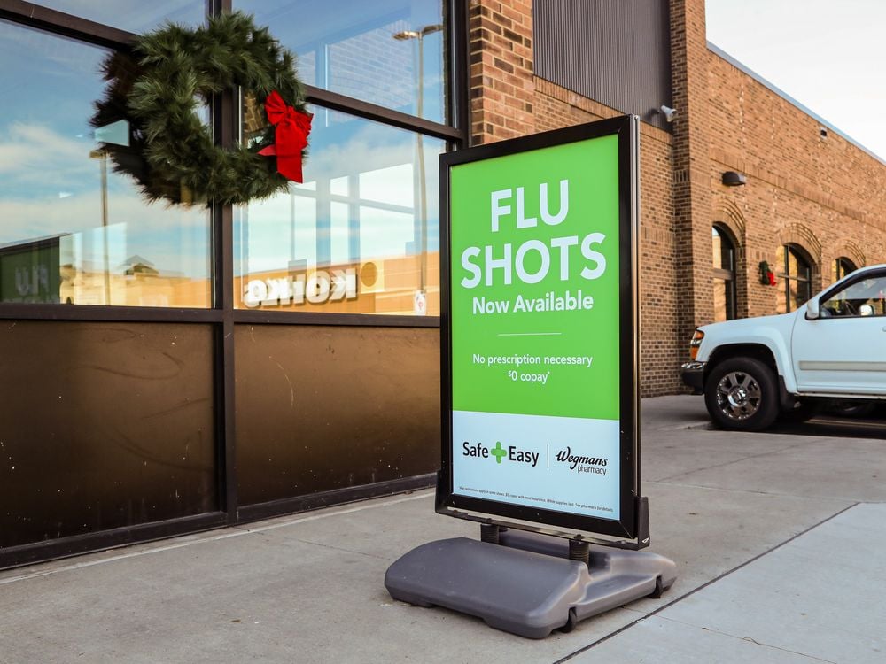 A sign for flu shots outside a Wegmans supermarket