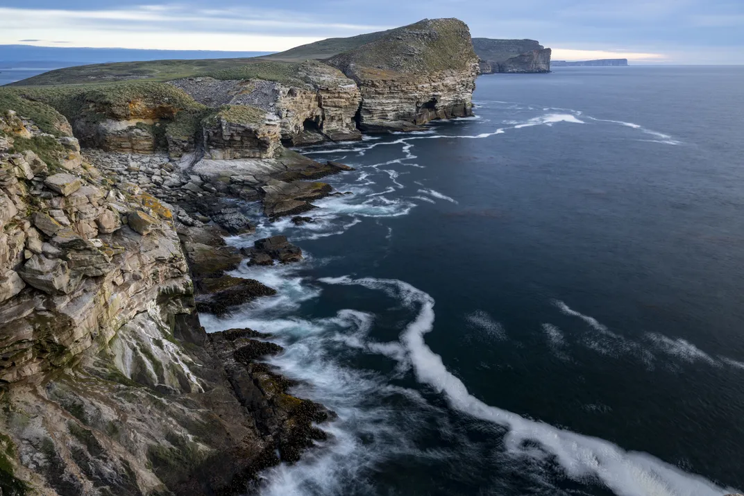 The west coast of New Island recedes into the distance. New Island has some of the steepest topography in the Falklands archipelago, with sheer cliffs plunging 250 feet into the sea.