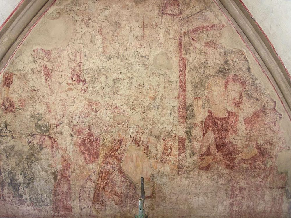 A very faded red and taupe frescoe with the outlines of some figures visible, enclosed in an arched dome