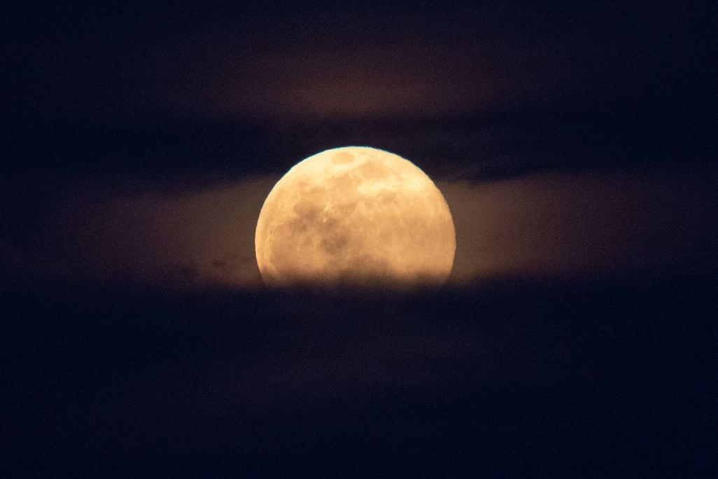 a full moon rises