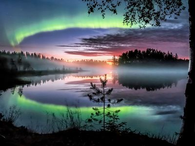 The aurora borealis, or Northern Lights, over a lake in eastern central Finland