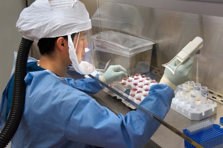 A CDC scientist harvests H7N9 virus that has been grown for sharing with partner laboratories for research purposes.