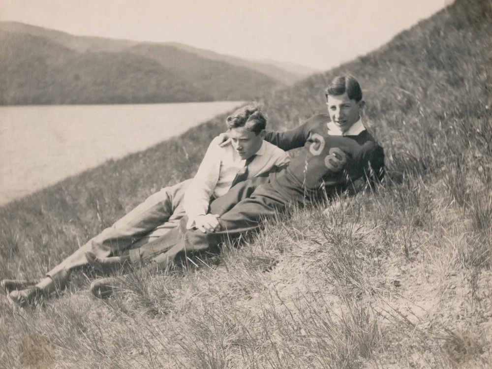 Black and white photo of two men on a hillside