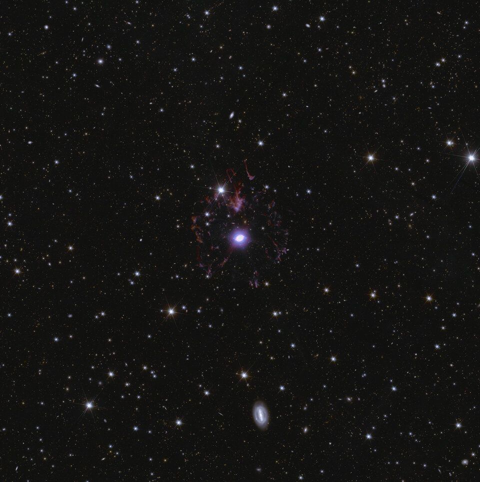view of space with many galaxies and a purple orb at the center