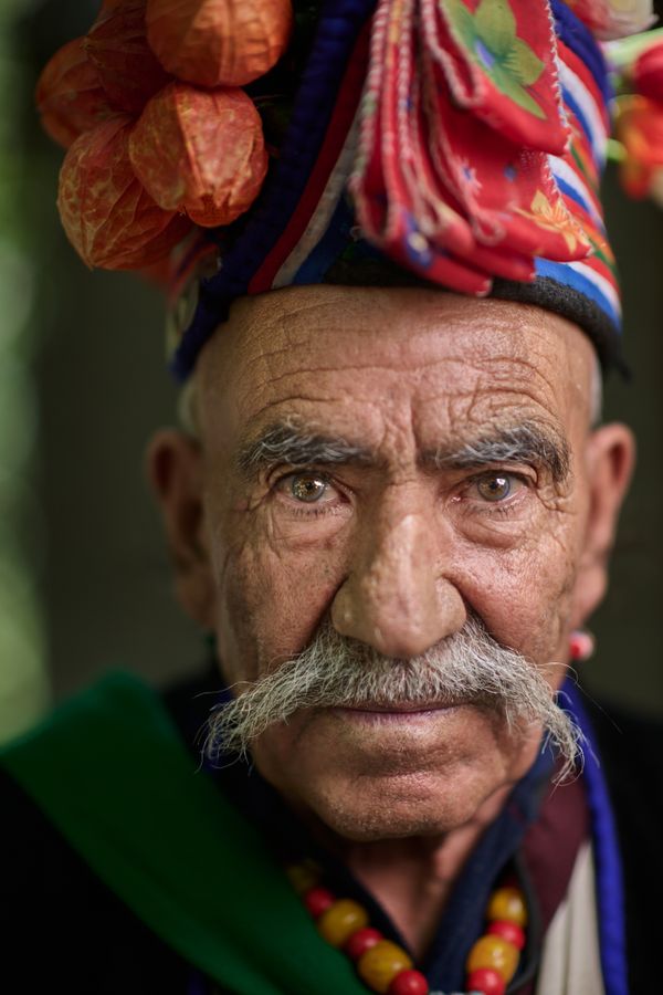 Aryan elder wearing traditional harvest hat thumbnail
