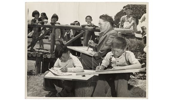Photograph of Chiura Obata teaching a children's art class at Tanforan Art School, 1942 / unidentified photographer. Chiura Obata papers, circa 1891-2000, 1942-1945. Archives of American Art, Smithsonian Institution.