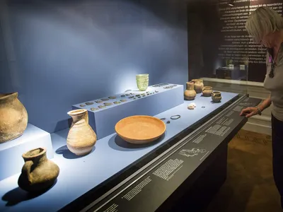 A visitor examines artifacts from the exhibition &quot;Crimea: Gold and Secrets of the Black Sea&quot; at the Allard Pierson Museum in Amsterdam in 2014.
