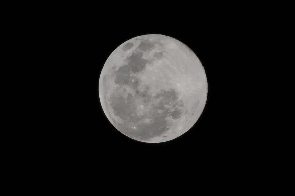 a full moon with a black background