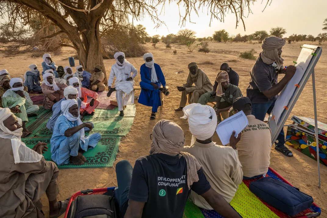A meeting between local residents and representatives from African Parks, the organization that stewards the Ennedi reserve, to discuss ways to minimize conflict between domesticated animals and wildlife.
