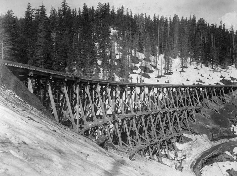 Men standing on a Northern Pacific Railway trestle in Washington, circa 1887