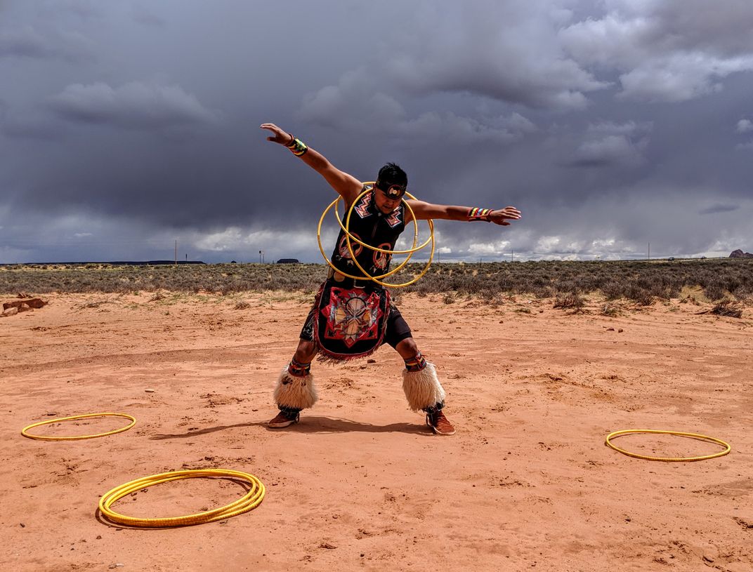 Navajo dancer performs a traditional hoop dance in the desert