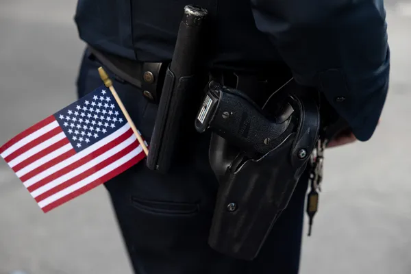 An Officer and Their Firearm During Veterans Day thumbnail