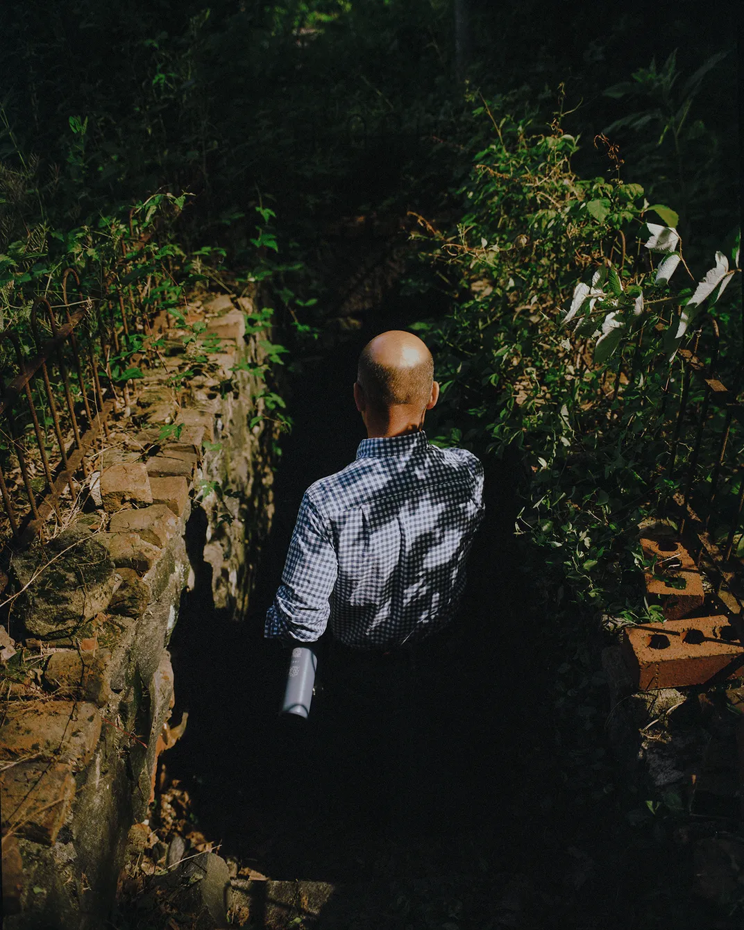 Paul Orpello, director of gardens and horticulture at the Hagley Foundation, descends from the Refinery Terrace to the Azalea Terrace in the Crowninshield Garden.