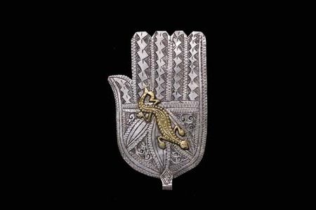 North African artisans combined gold and silver to forge jewelry like the khamsa.