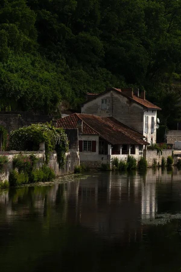 Reflections on the Dronne River in Brantome, France thumbnail