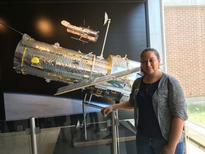 Astronomy intern Danielle Rowland stands with a model of the Hubble Space Telescope at the Space Telescope Science Institute in Baltimore.
