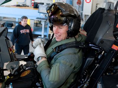 Major J.T. Bachmann pulls off the gloves and grins after an engine run in the F-35A.