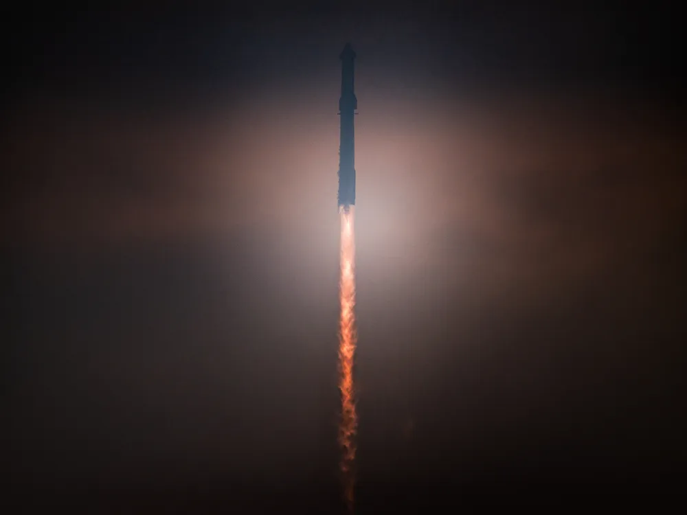 A rocket launches into a dark sky