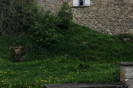 In the foreground stand foundation remnants of a house where soldiers once searched for Jews. The family hid refugees in a secret compartment constructed between the interior walls.