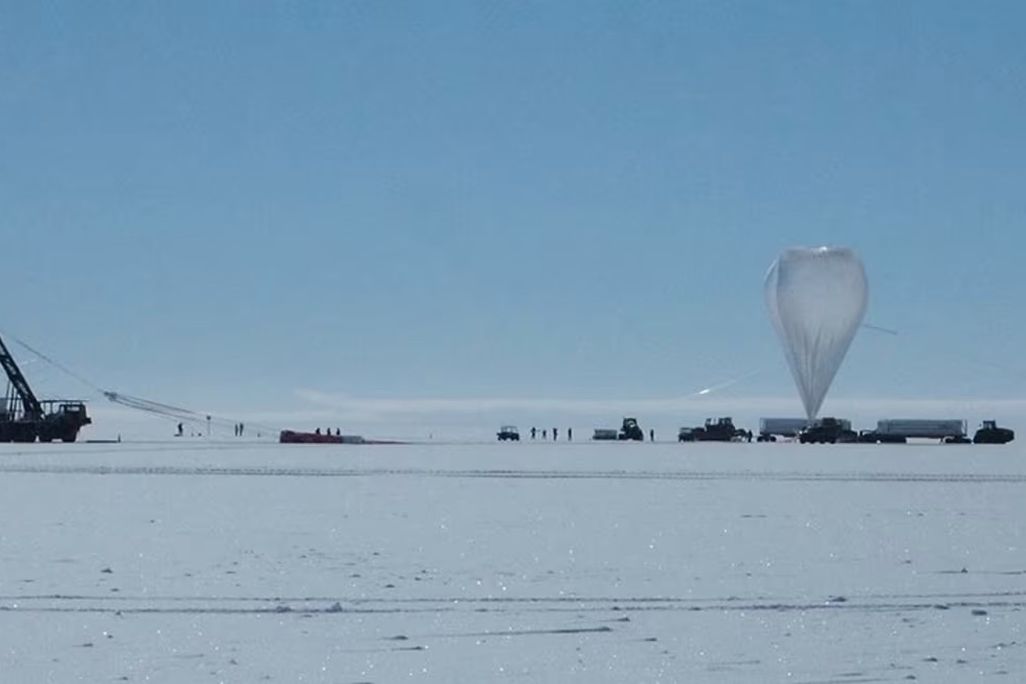 a balloon and other scientific equipment on the icy expanse of Antarctica