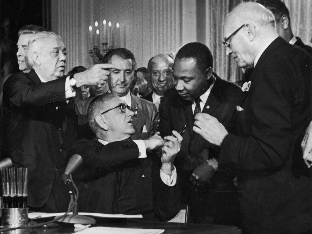 Lyndon Johnson shakes Martin Luther King's hand