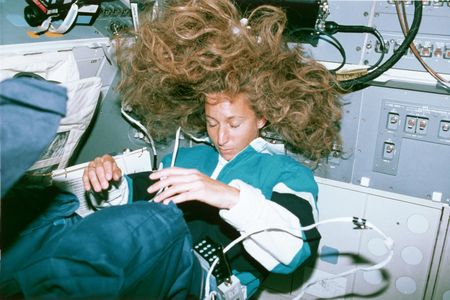 Marsha Ivins takes a nap on the Space Shuttle Atlantis. 