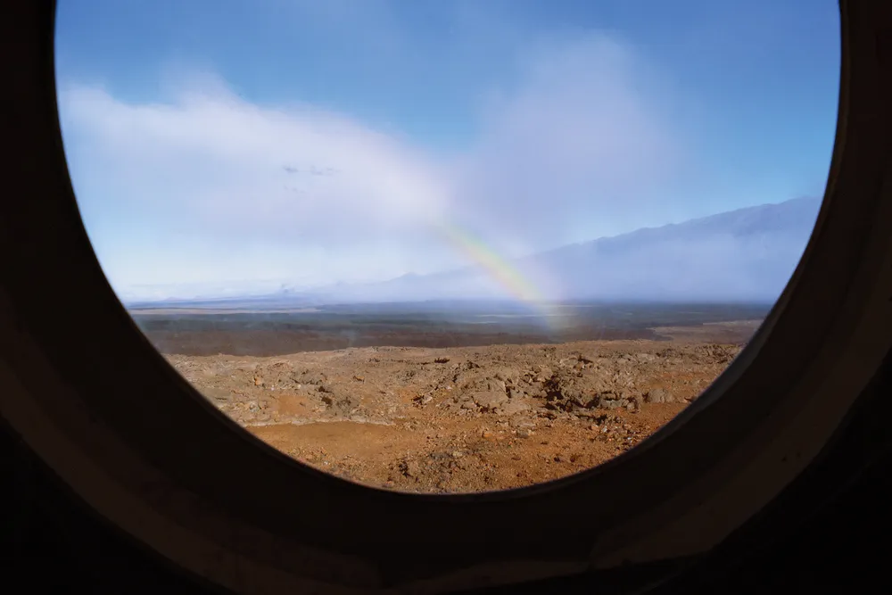 A rainbow on rugged landscape
