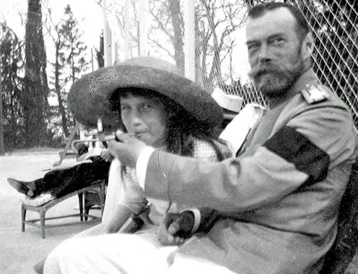 Anastasia smoking a cigarette held by her father, Nicholas II