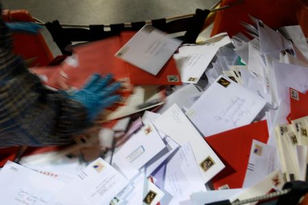 A pile of letters wait to be loaded in a sorting machine at a USPS processing and distribution center.