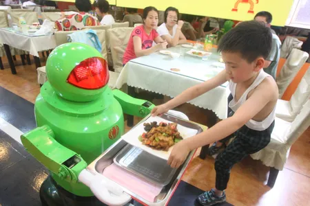 A robot serves a customer at a restaurant in northeast China in 2012
