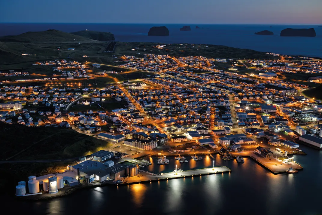 The lights of Vestmannaeyjabaer, the only town in the Westman Islands. The fishing hamlet is a 40-minute ferry ride from Iceland’s mainland.