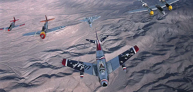 At the 2002 Nellis Air Show near Las Vegas, a Sabre heads up an A team in a USAF Heritage Flight: (from left) P-51 Mustang, P-47 Thunderbolt, F-15 Eagle, P-38 Lightning, and TF-51.