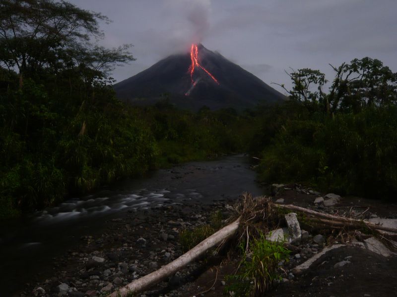 Arenal volcano spewing lava at night... in its normal behavior night ...