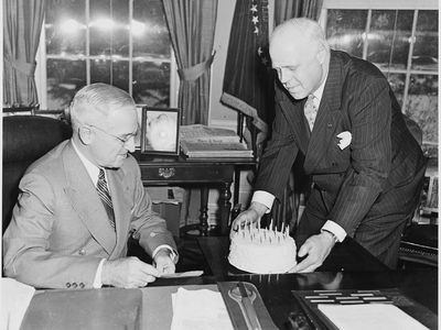 President Truman receives a birthday cake in the Oval Office in 1951. Six years earlier, his birthday coincided with V-E Day. 