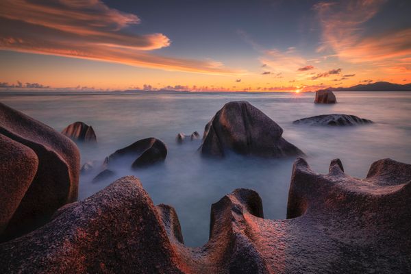 Amazing sunset at the world famous Anse Source d'Argent on La Digue island in Seychelles.