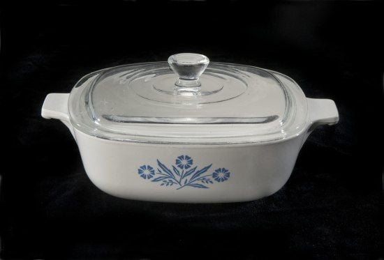 A white casserole dish with blue floral designs