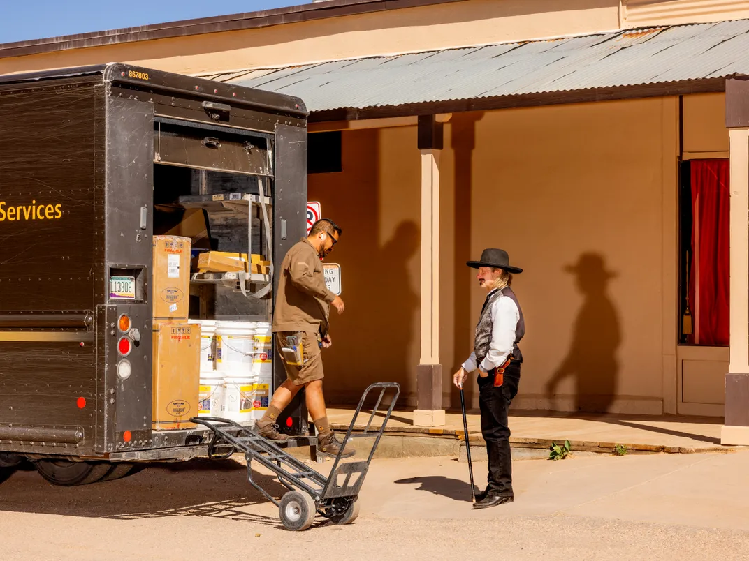 A cowboy re-enactor accepts a UPS package