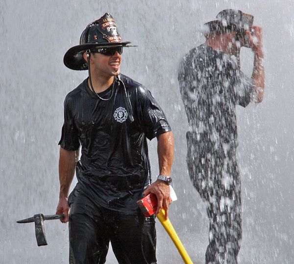 San Francisco firemen enjoying task of shutting off fire hydrant rammed by truck thumbnail