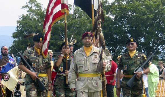 On mid-tour leave from Operation Iraqi Freedom, Sergeant First Class Chuck Boers carries in the eagle staff at the Shenandoah Powwow, 2004. (Courtesy of Chuck Boers)