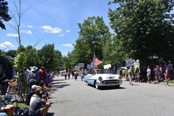 A variety of vehicles and social matter signs in Montclair, NJ 2022 4th of July Day Parade thumbnail