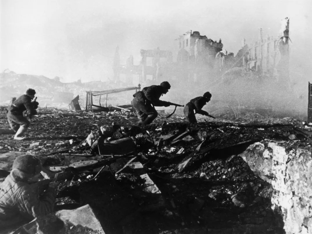 Soviet Red Army troops storm an apartment block in war-torn Stalingrad in 1941.
