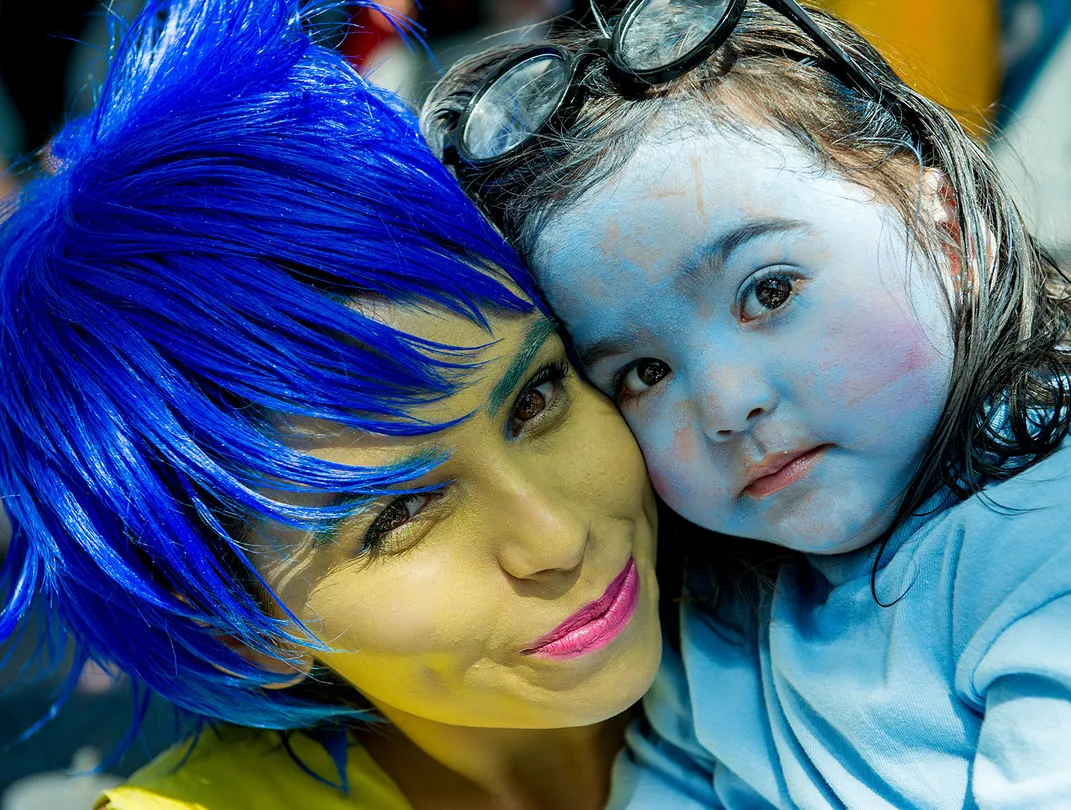 Mother and daughter dress up as Joy and Sadness from Pixar's Inside Out franchise.